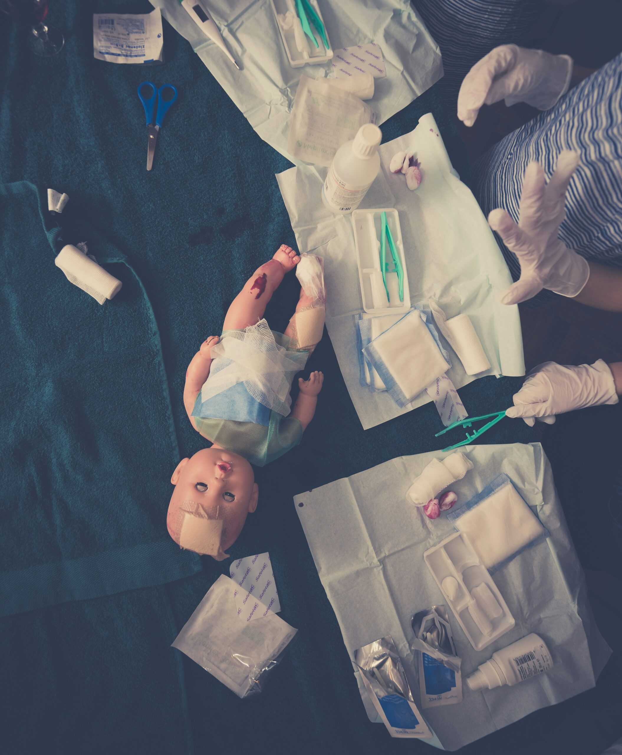 baby in white dress shirt lying on blue textile