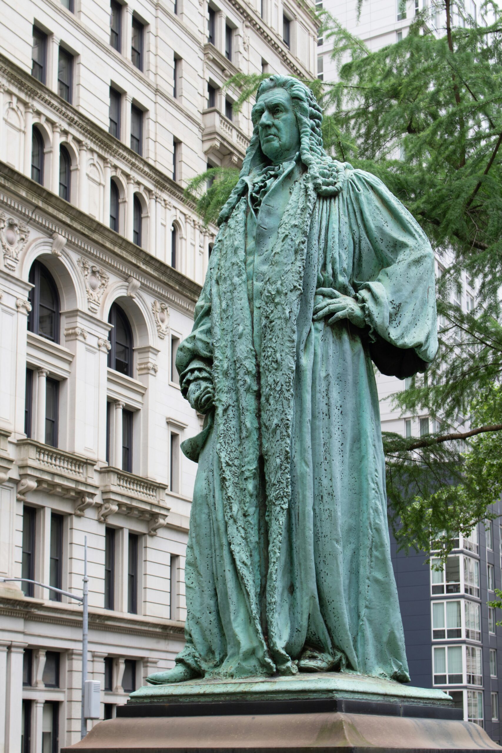 A statue of a man standing in front of a building