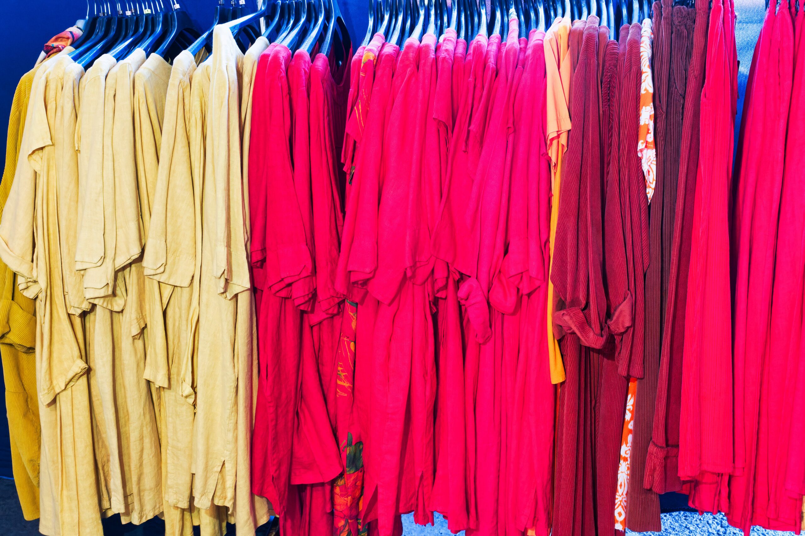 A rack of dresses hanging in a store